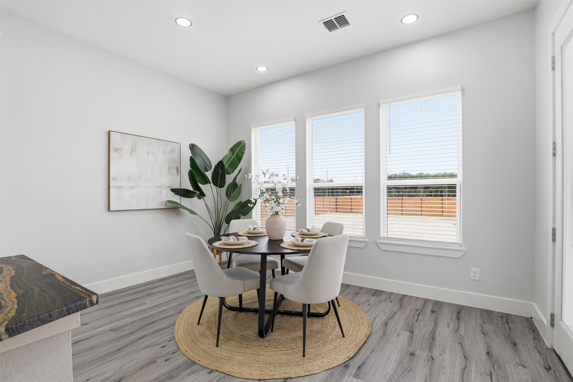 113 Los Robles Road Elgin, TX 78621 - Photo 6 of 20 Dining area with wood-finish flooring, recessed lighting, and a countertop featuring natural stone