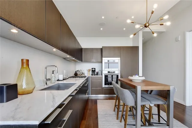 a kitchen with counter space dining table and stainless steel appliances