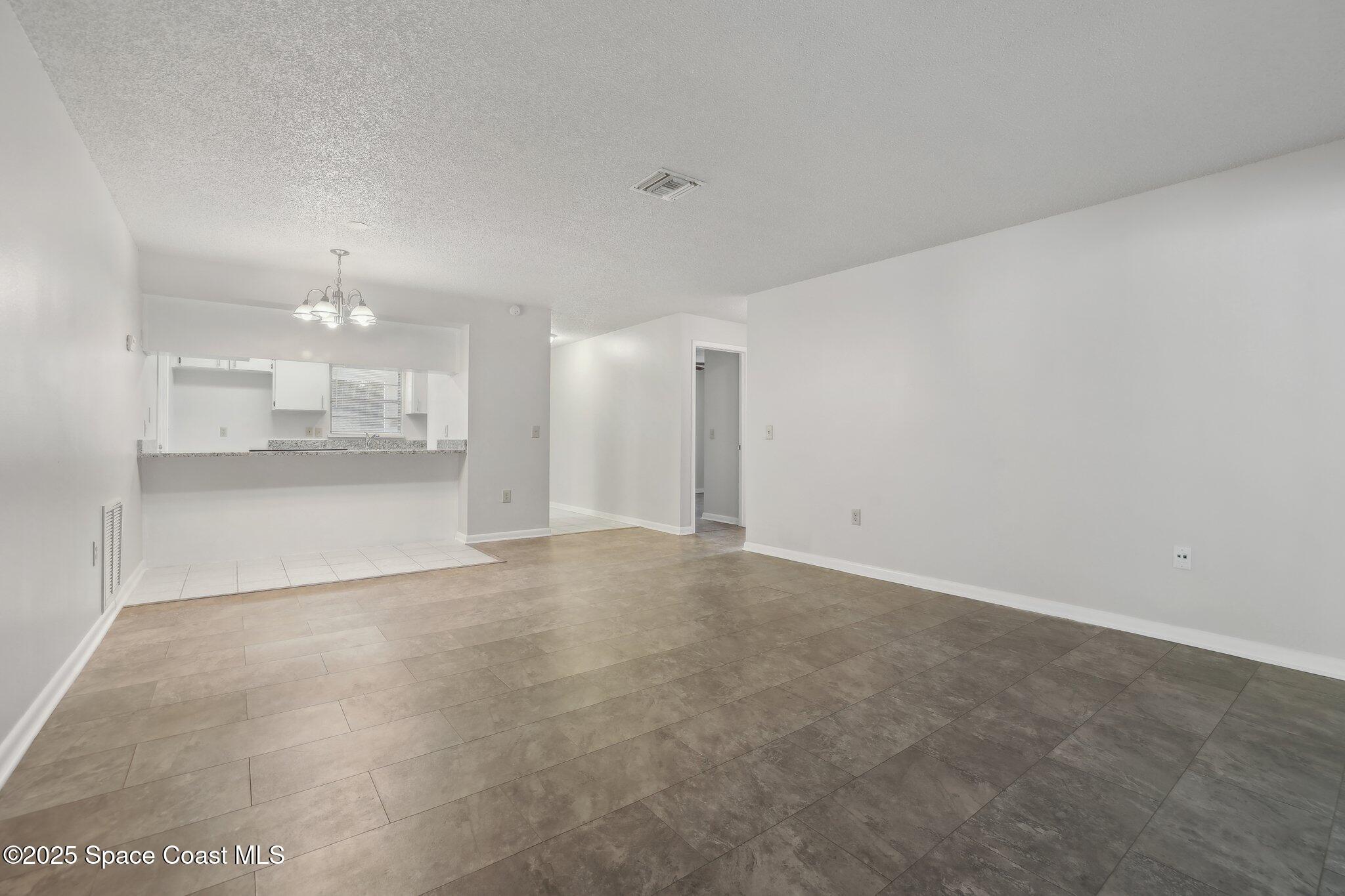 3837 Parapet Drive Cocoa, FL 32926 - Photo 15 of 42 a view of a big room with a kitchen