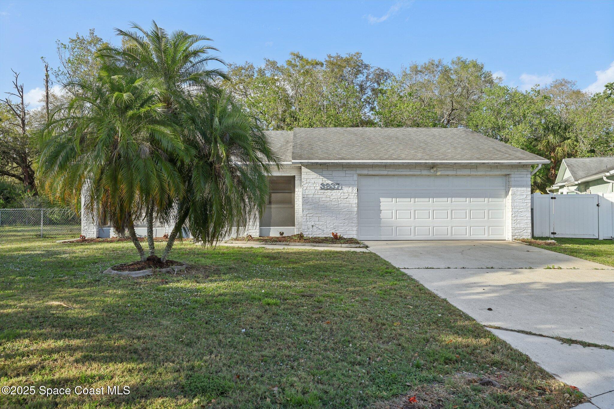 3837 Parapet Drive Cocoa, FL 32926 - Photo 2 of 42 a front view of a house with a yard