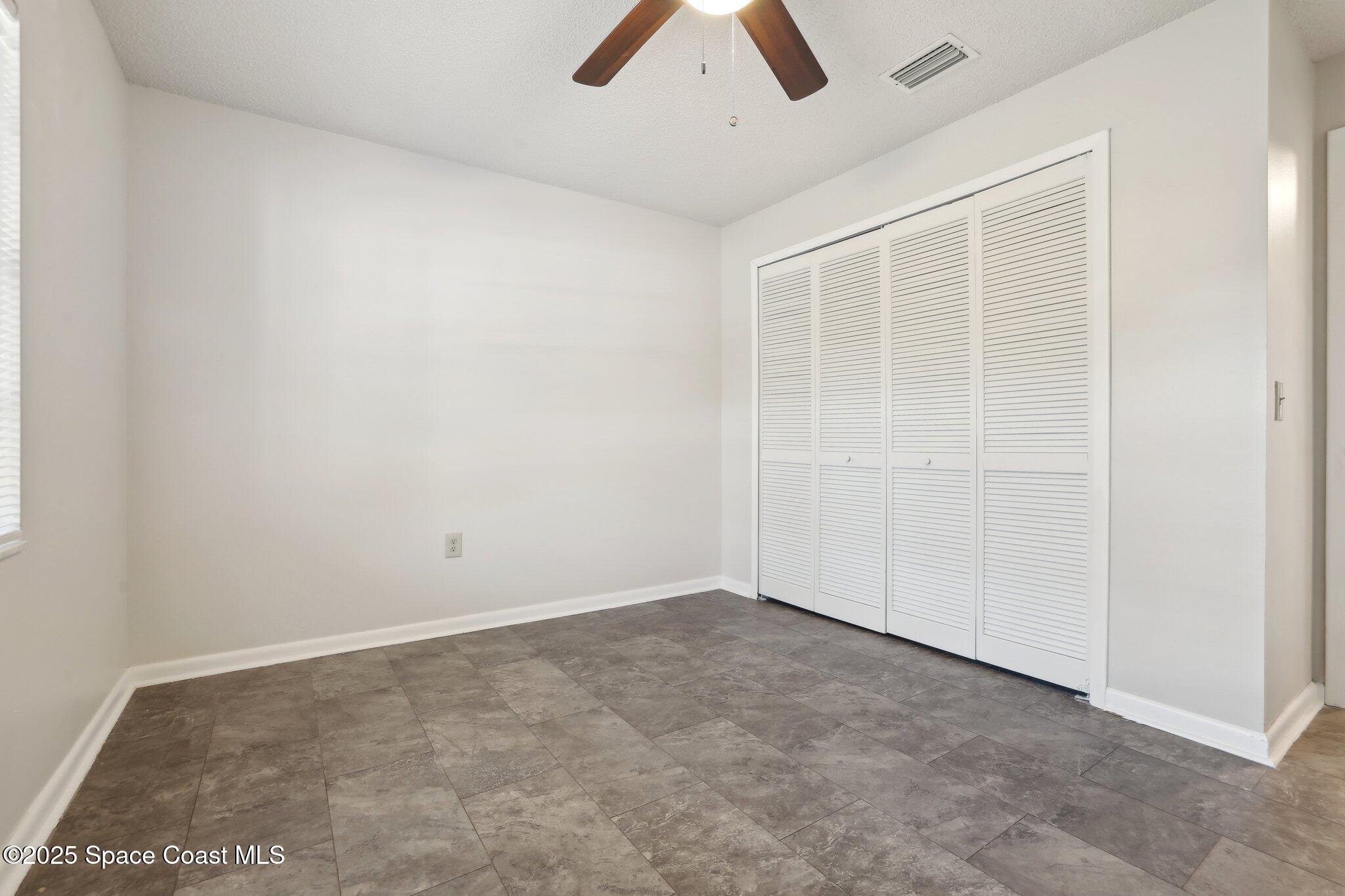 3837 Parapet Drive Cocoa, FL 32926 - Photo 28 of 42 an empty room with ceiling fan