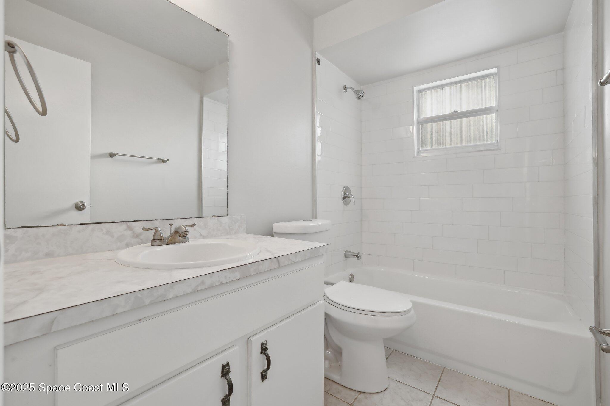 3837 Parapet Drive Cocoa, FL 32926 - Photo 29 of 42 a bathroom with a sink a toilet and shower