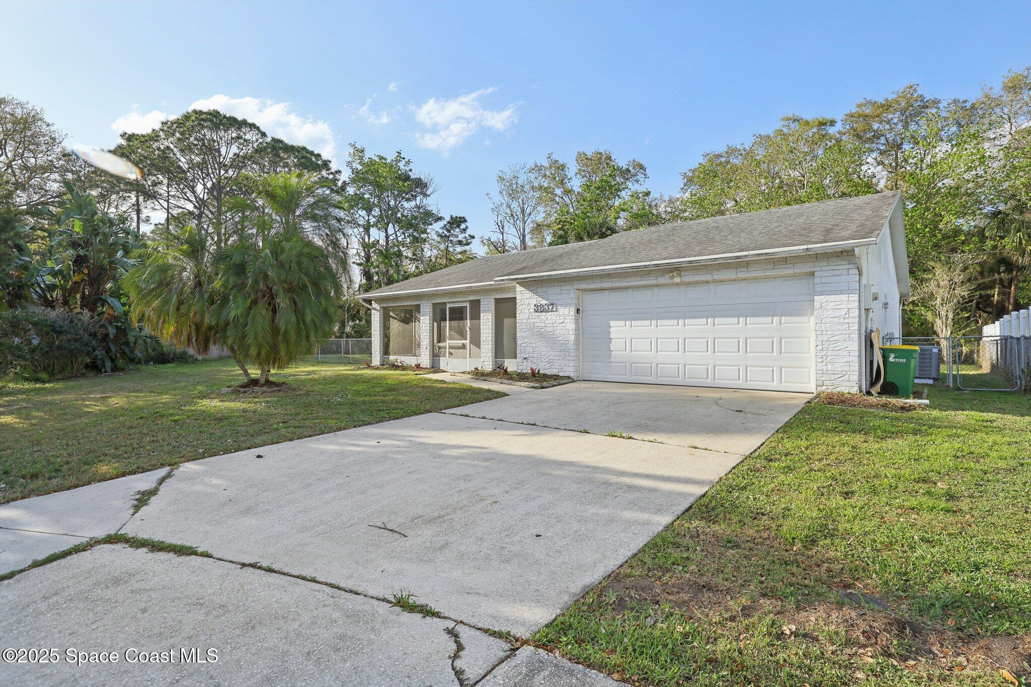 3837 Parapet Drive Cocoa, FL 32926 - Photo 3 of 42 front view of a house with a yard