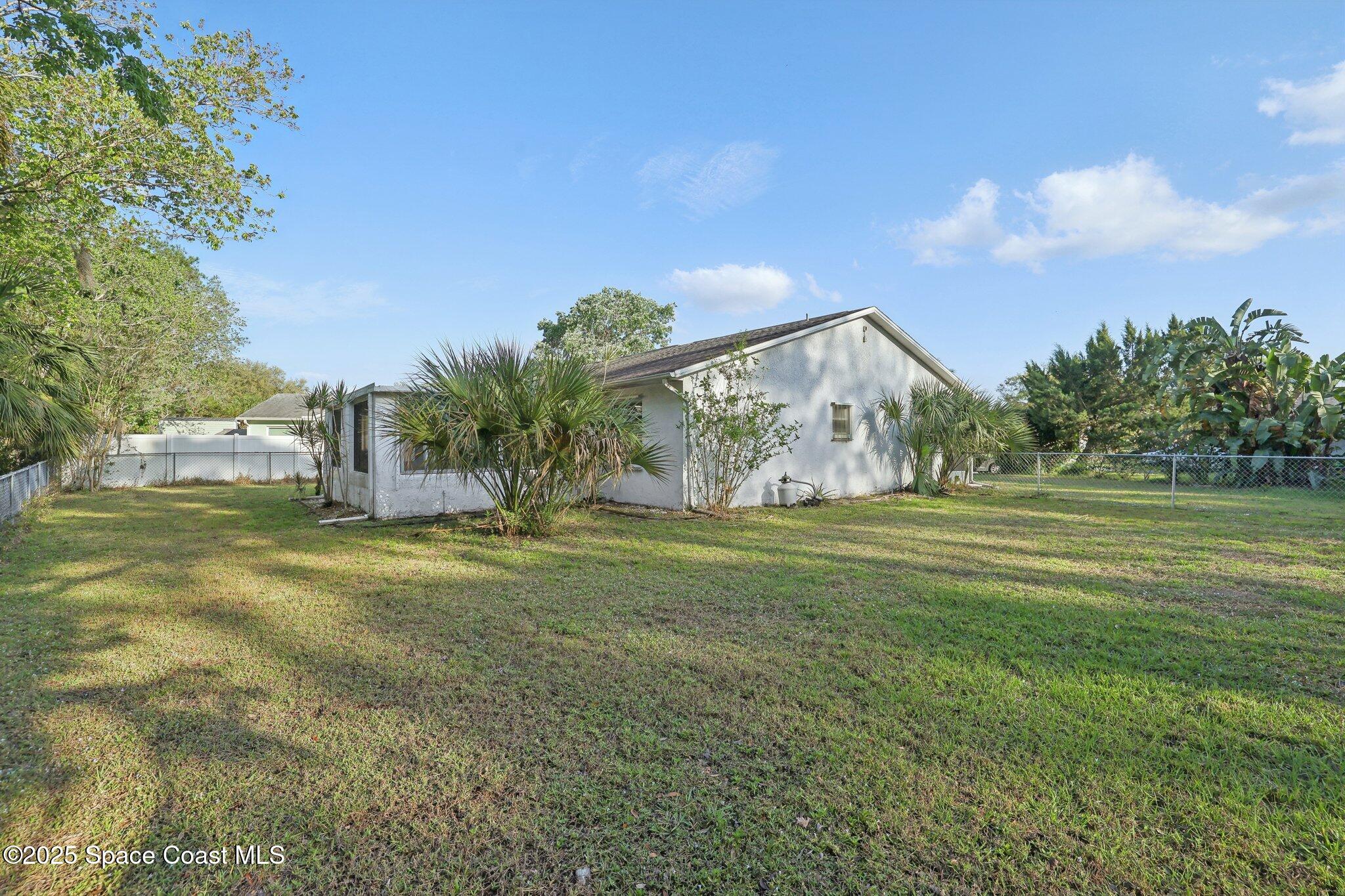 3837 Parapet Drive Cocoa, FL 32926 - Photo 41 of 42 a view of a big yard with large trees