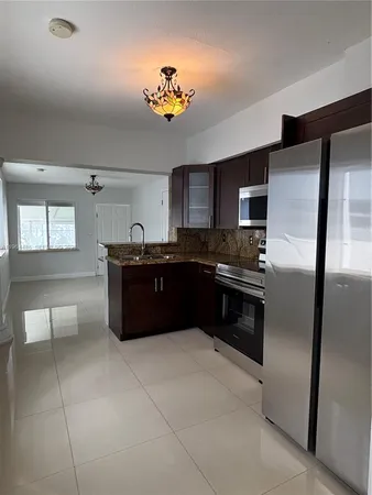 a kitchen with a stove sink and refrigerator
