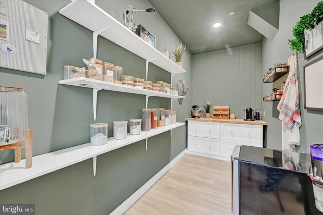 a room with stainless steel appliances kitchen island granite countertop a sink and cabinets