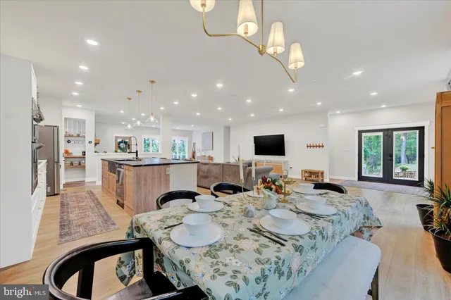 a living room with furniture kitchen view and a large window
