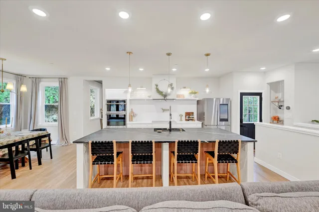a large kitchen with a table and chairs