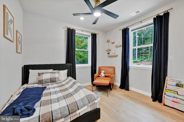 a bedroom with furniture and a window