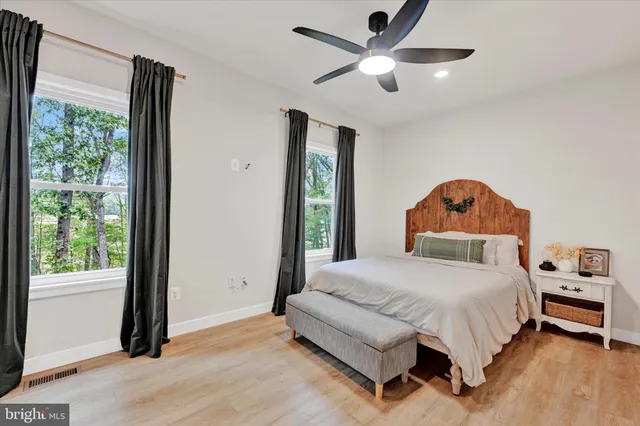 a bedroom with a bed and a large window