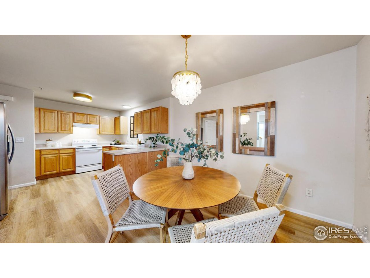 2621 Rigden Parkway, Unit 4 Fort Collins, CO 80525 - Photo 11 of 28 a living room with stainless steel appliances kitchen island granite countertop a view of kitchen dining table and chairs