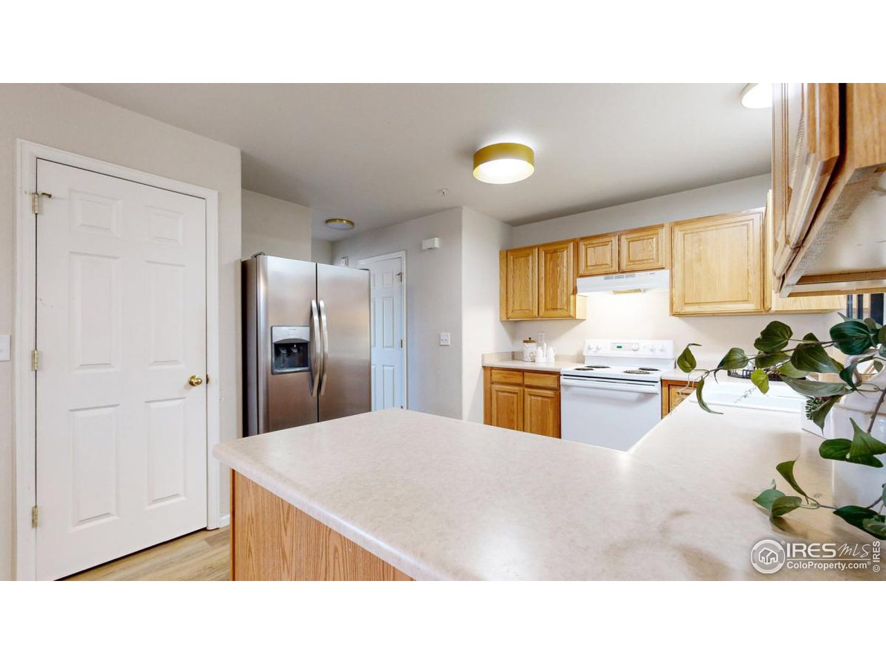 2621 Rigden Parkway, Unit 4 Fort Collins, CO 80525 - Photo 13 of 28 a kitchen with stainless steel appliances kitchen island granite countertop a refrigerator and a sink