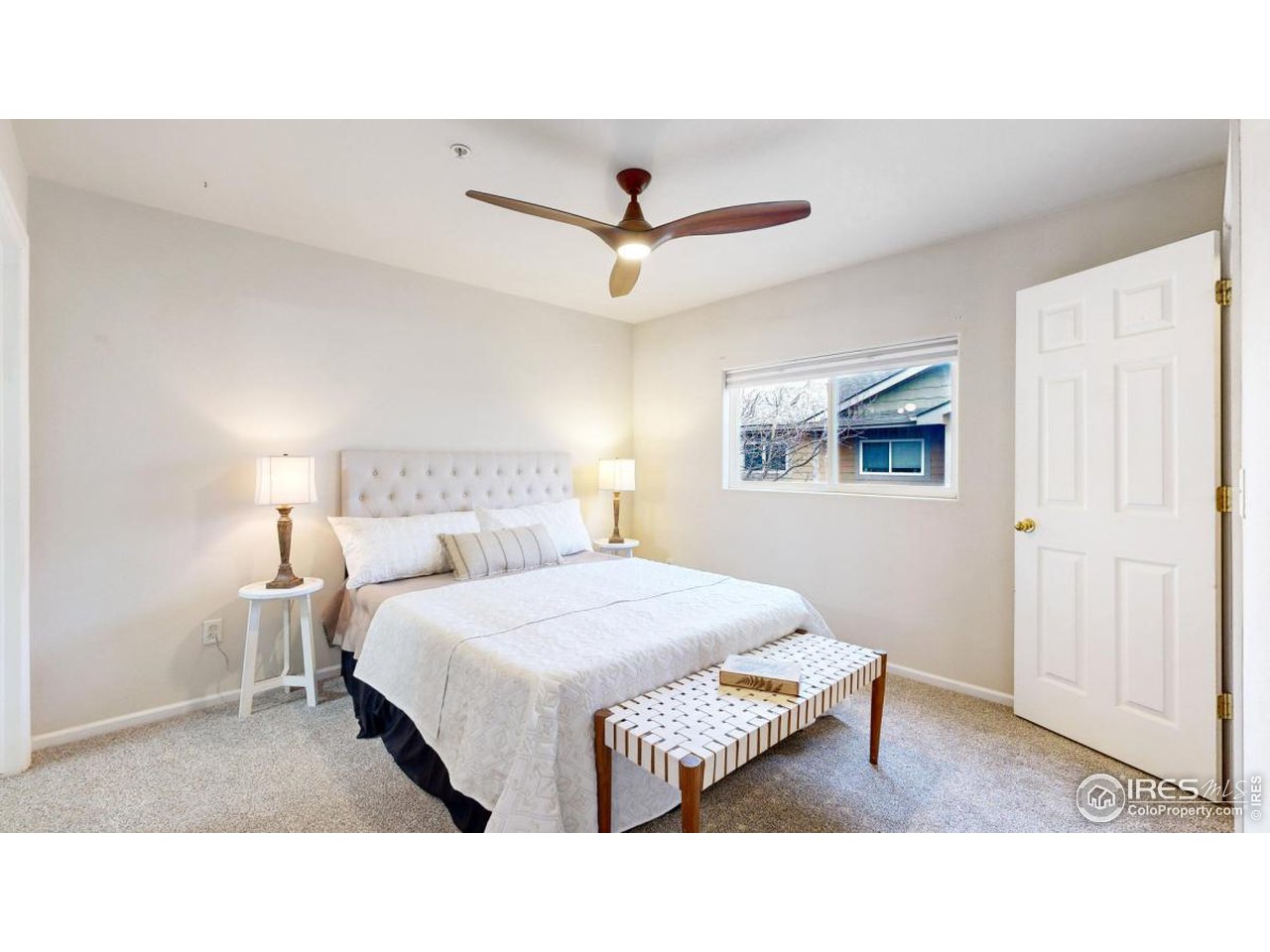 2621 Rigden Parkway, Unit 4 Fort Collins, CO 80525 - Photo 15 of 28 a bedroom with a bed and a chandelier