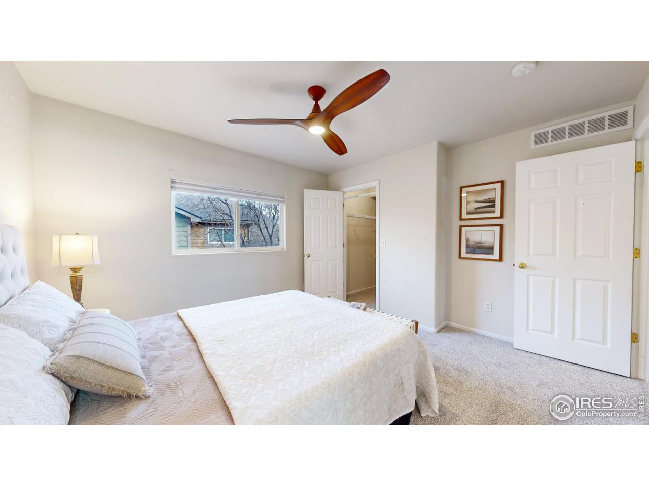 2621 Rigden Parkway, Unit 4 Fort Collins, CO 80525 - Photo 17 of 28 a bedroom with a bed and a painting