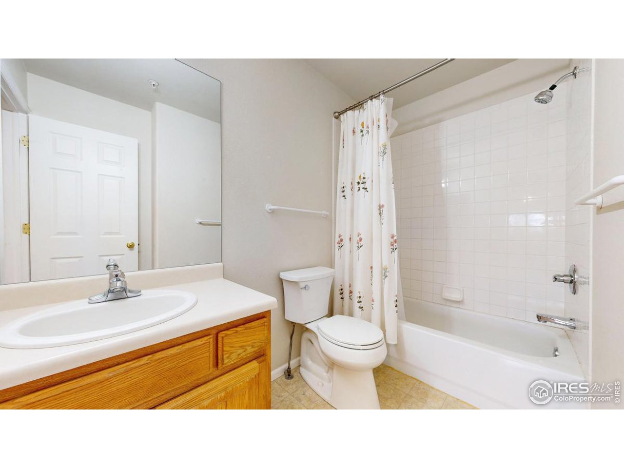 2621 Rigden Parkway, Unit 4 Fort Collins, CO 80525 - Photo 21 of 28 a bathroom with a sink toilet a mirror and shower