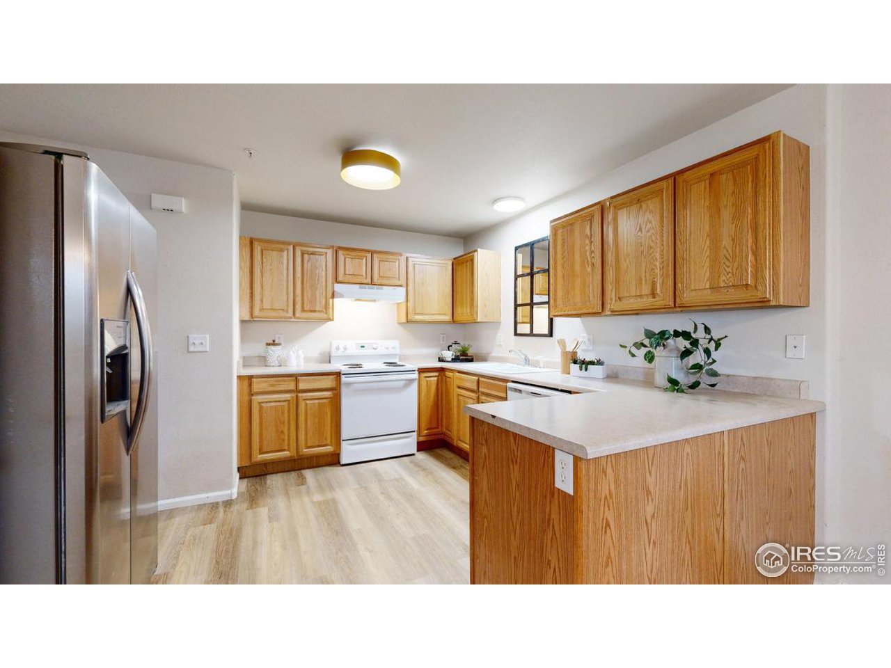 2621 Rigden Parkway, Unit 4 Fort Collins, CO 80525 - Photo 10 of 28 a kitchen with stainless steel appliances a sink a refrigerator and a window
