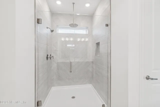 a bathroom with a bathtub and a shower