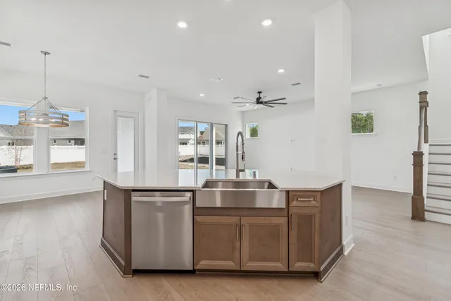 a kitchen with stainless steel appliances granite countertop a sink and a refrigerator