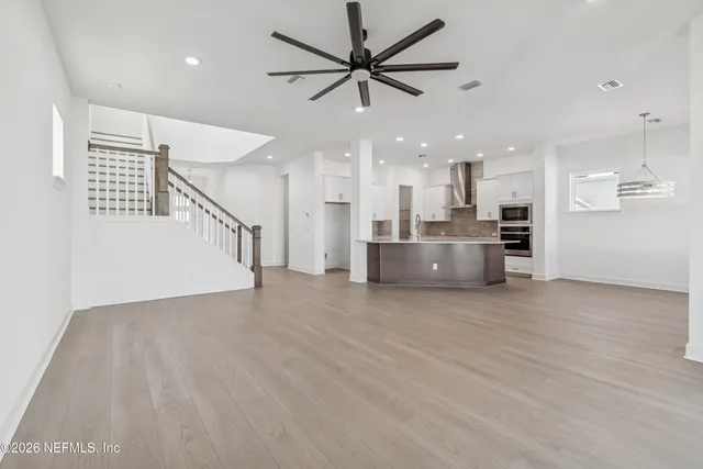 a view of a kitchen with a stove cabinets and wooden floor