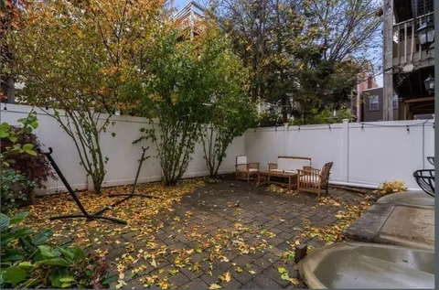 a backyard of a house with table and chairs