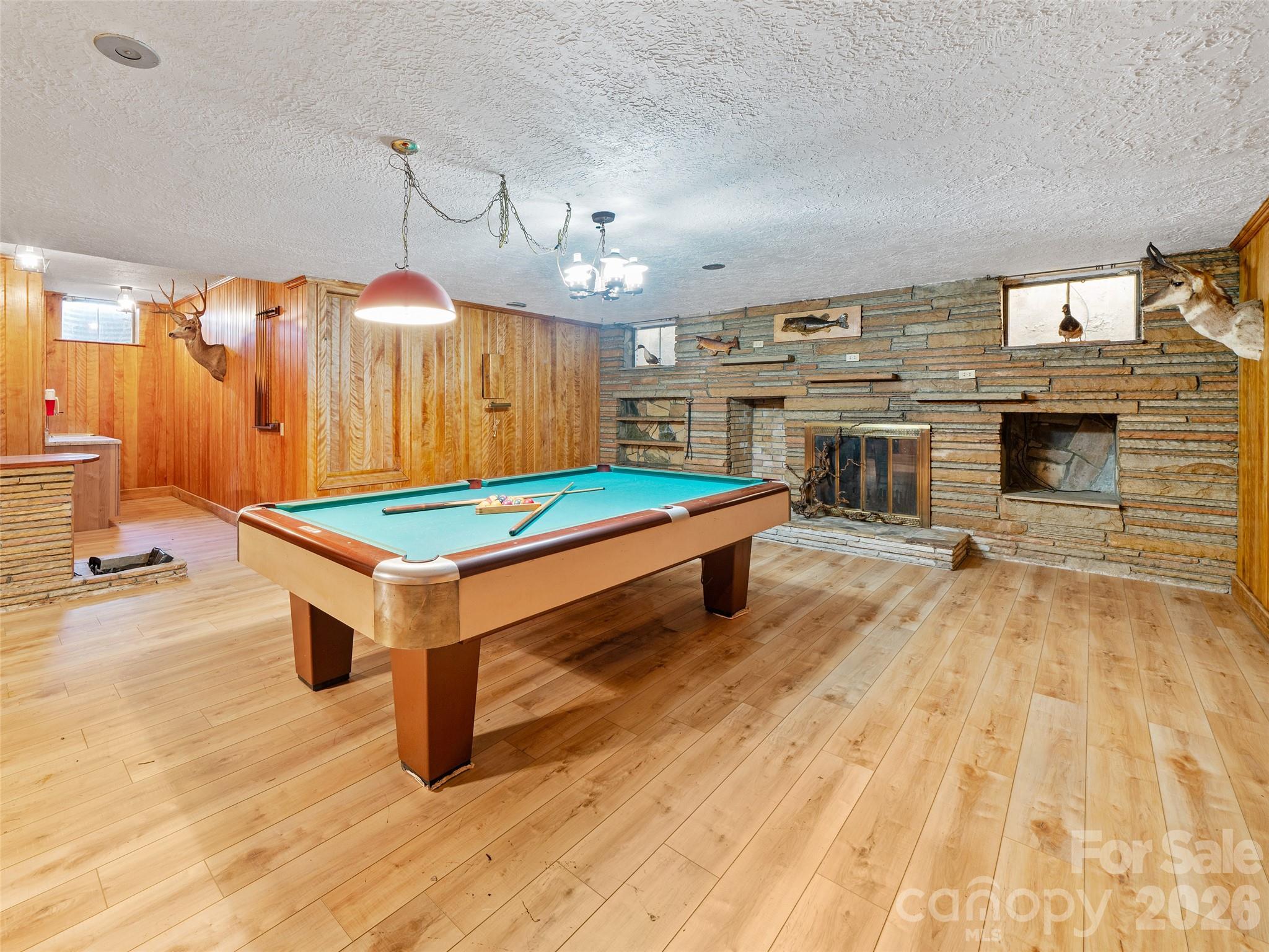 110 Crest View Road Burnsville, NC 28714 - Photo 15 of 45 a living room with pool table and a fireplace