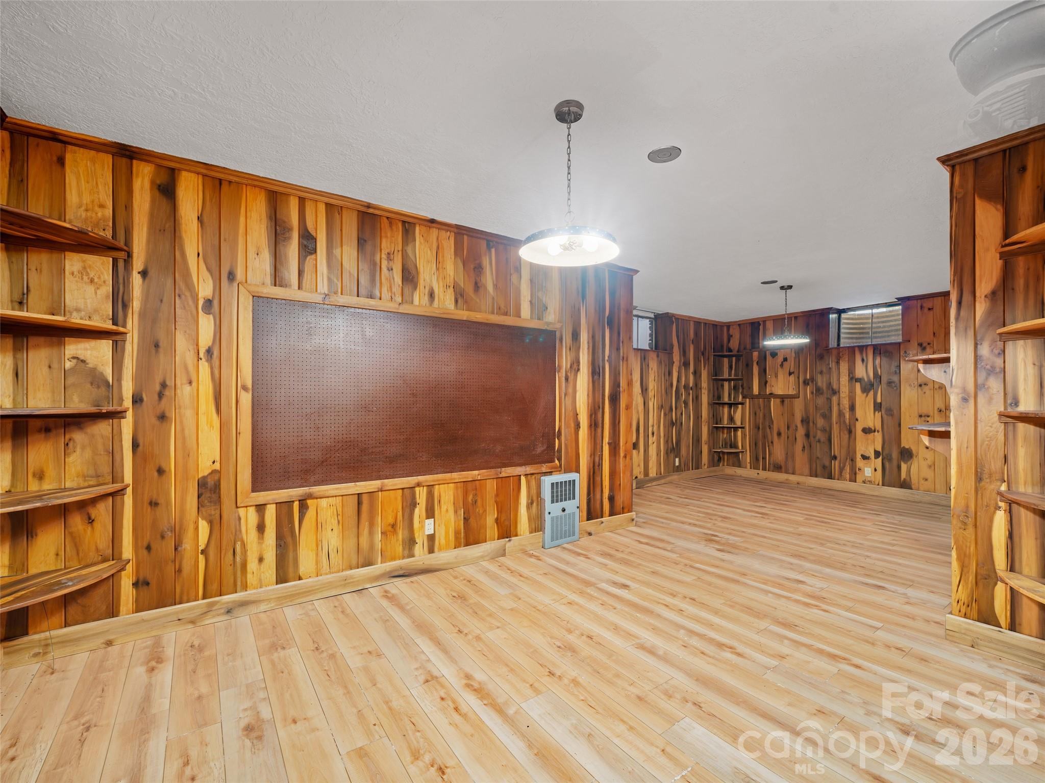 110 Crest View Road Burnsville, NC 28714 - Photo 17 of 45 a big room with wooden floor closet and windows