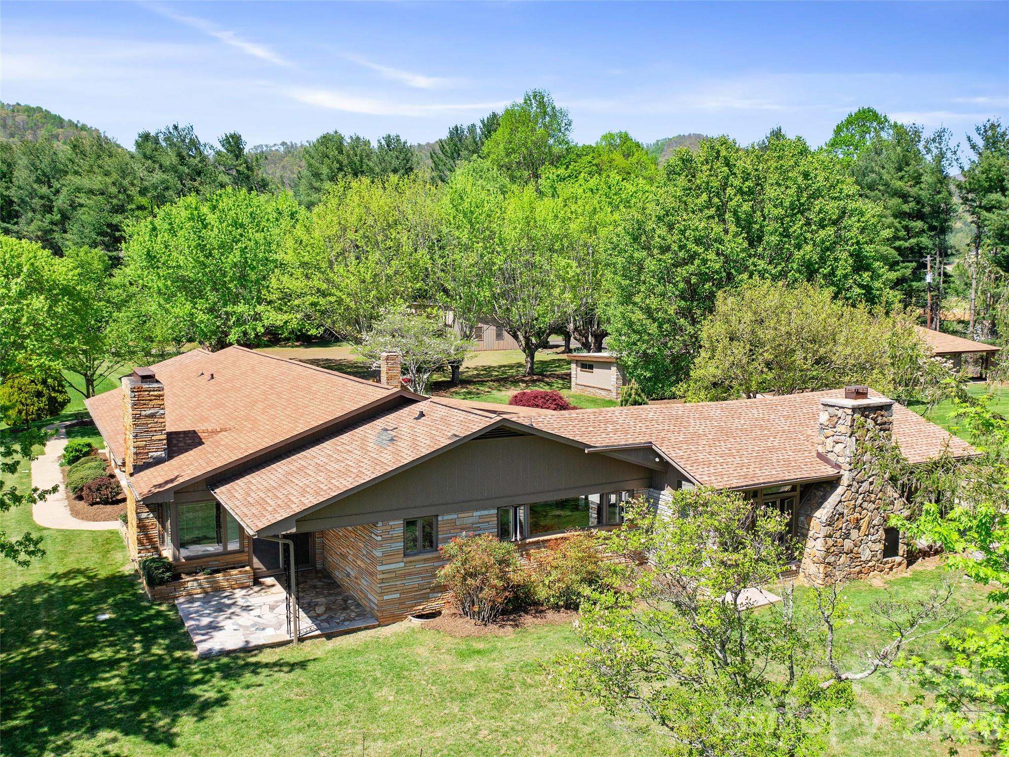 110 Crest View Road Burnsville, NC 28714 - Photo 23 of 45 a view of a house with a big yard plants and large trees