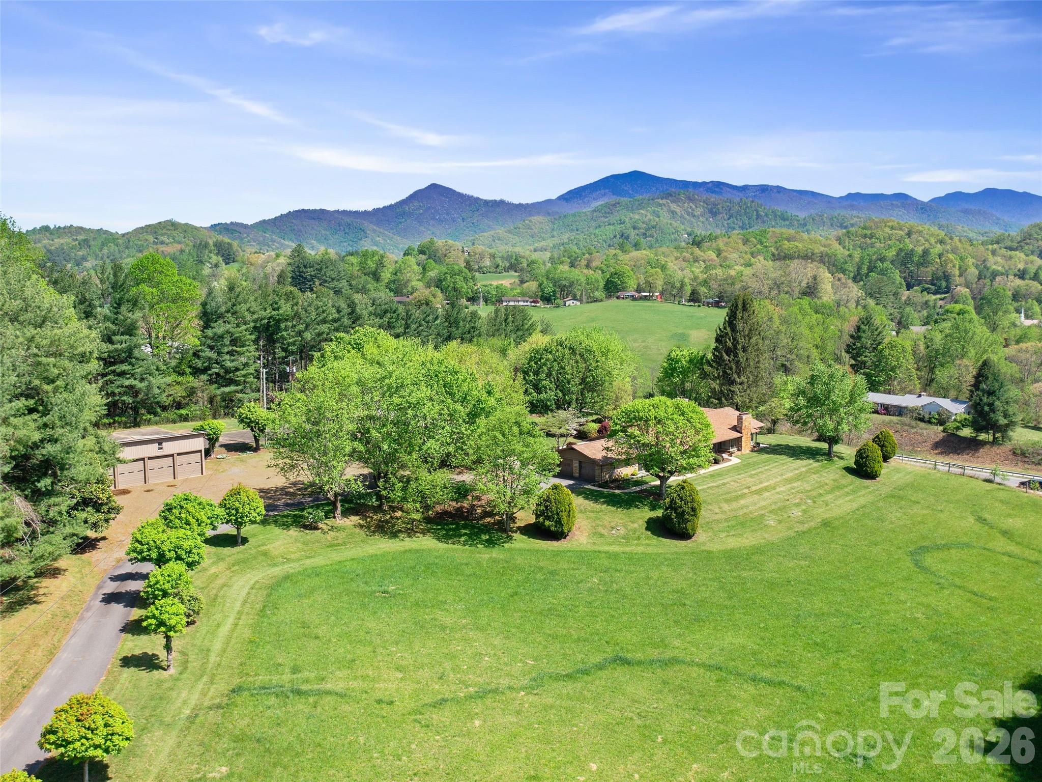 110 Crest View Road Burnsville, NC 28714 - Photo 25 of 45 a view of a garden with a houses