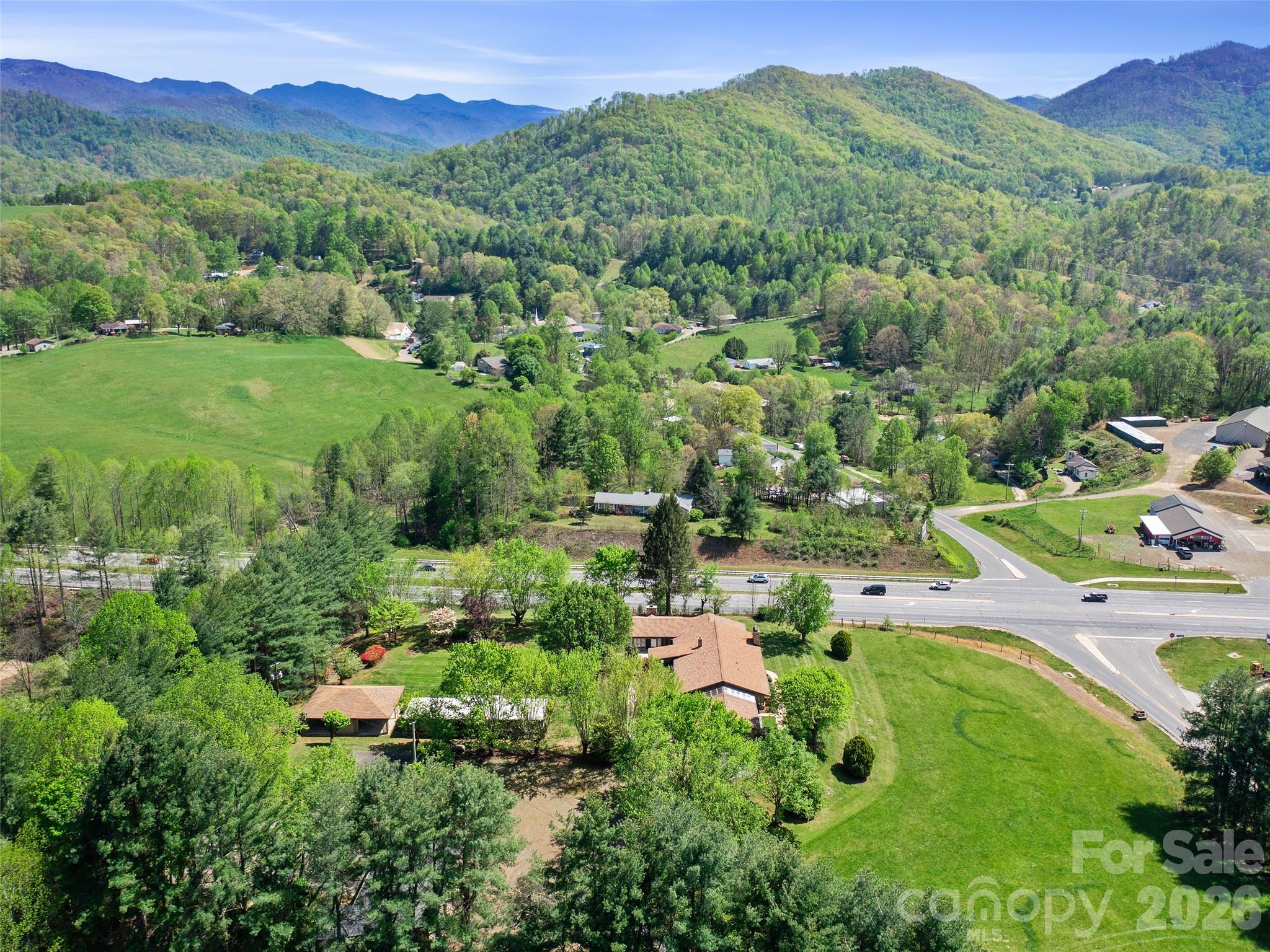 110 Crest View Road Burnsville, NC 28714 - Photo 26 of 45 a view of a lush green hillside and houses
