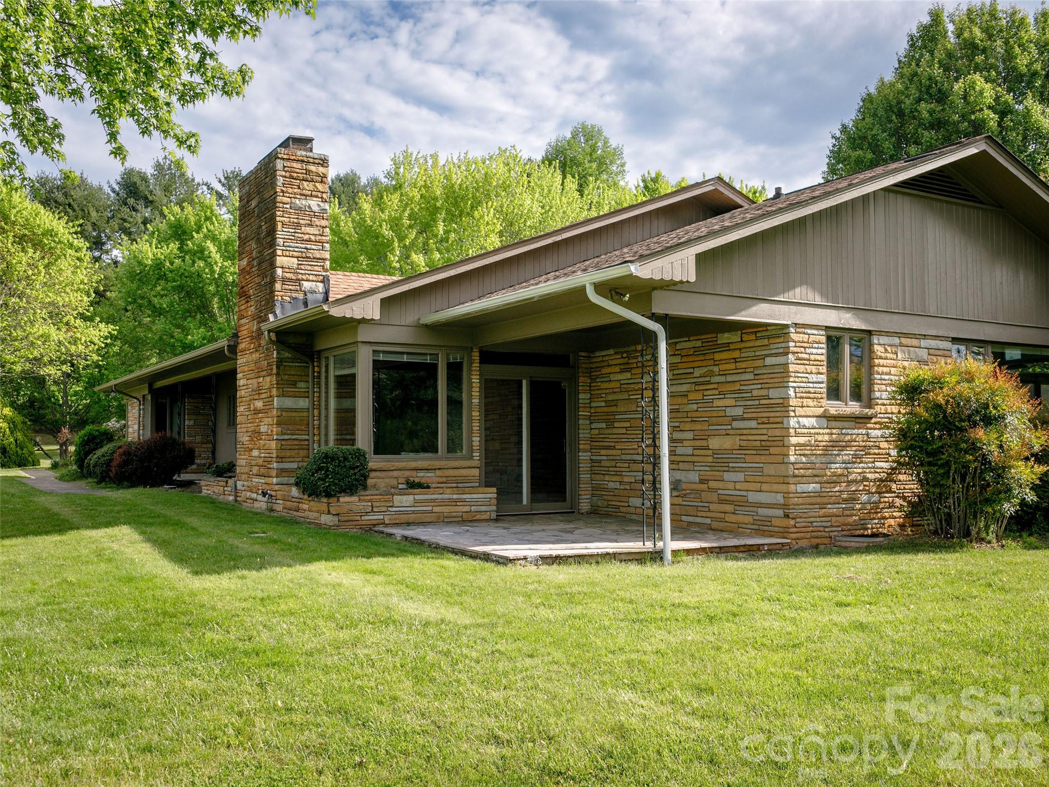 110 Crest View Road Burnsville, NC 28714 - Photo 42 of 45 a front view of a house with a garden