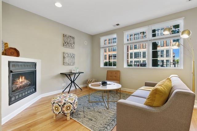 2349 West Harrison Street, Unit 1 Chicago, IL 60612 - Photo 2 of 25 a living room with furniture and a fireplace