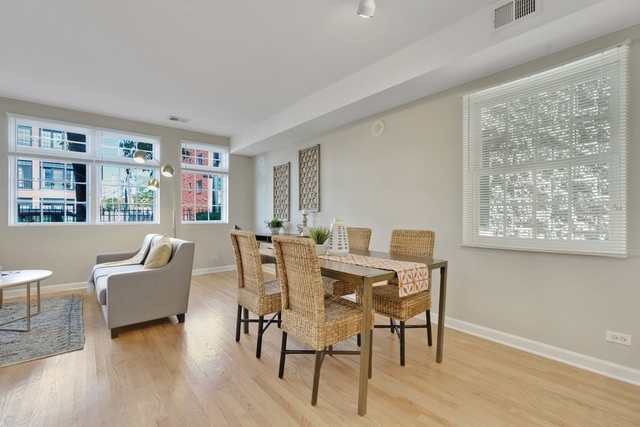 2349 West Harrison Street, Unit 1 Chicago, IL 60612 - Photo 11 of 25 a view of a dining room with furniture window and wooden floor