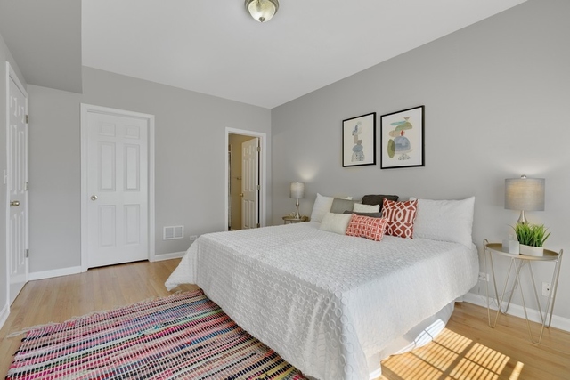 2349 West Harrison Street, Unit 1 Chicago, IL 60612 - Photo 13 of 25 a bedroom with a bed and a lamp