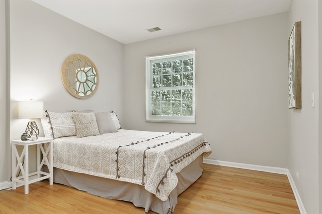 2349 West Harrison Street, Unit 1 Chicago, IL 60612 - Photo 16 of 25 a bedroom with a bed and a window
