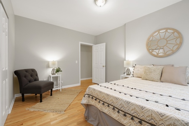2349 West Harrison Street, Unit 1 Chicago, IL 60612 - Photo 18 of 25 a bedroom with a bed and chair