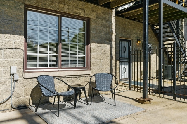 2349 West Harrison Street, Unit 1 Chicago, IL 60612 - Photo 20 of 25 a balcony with table and chairs