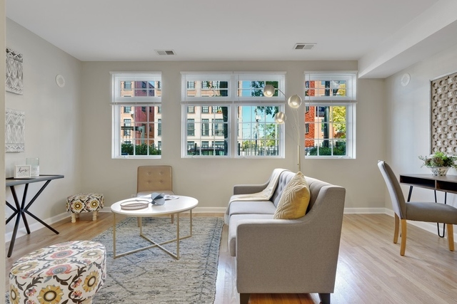 2349 West Harrison Street, Unit 1 Chicago, IL 60612 - Photo 4 of 25 a living room with furniture and wooden floor