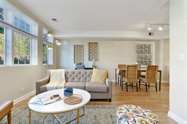 2349 West Harrison Street, Unit 1 Chicago, IL 60612 - Photo 5 of 25 a living room with furniture and a dining table