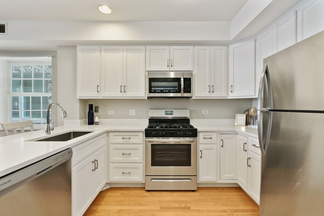 2349 West Harrison Street, Unit 1 Chicago, IL 60612 - Photo 9 of 25 a kitchen with white cabinets and white appliances