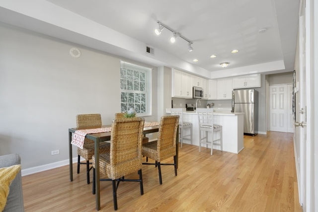 2349 West Harrison Street, Unit 1 Chicago, IL 60612 - Photo 10 of 25 a view of a dining room with furniture and wooden floor