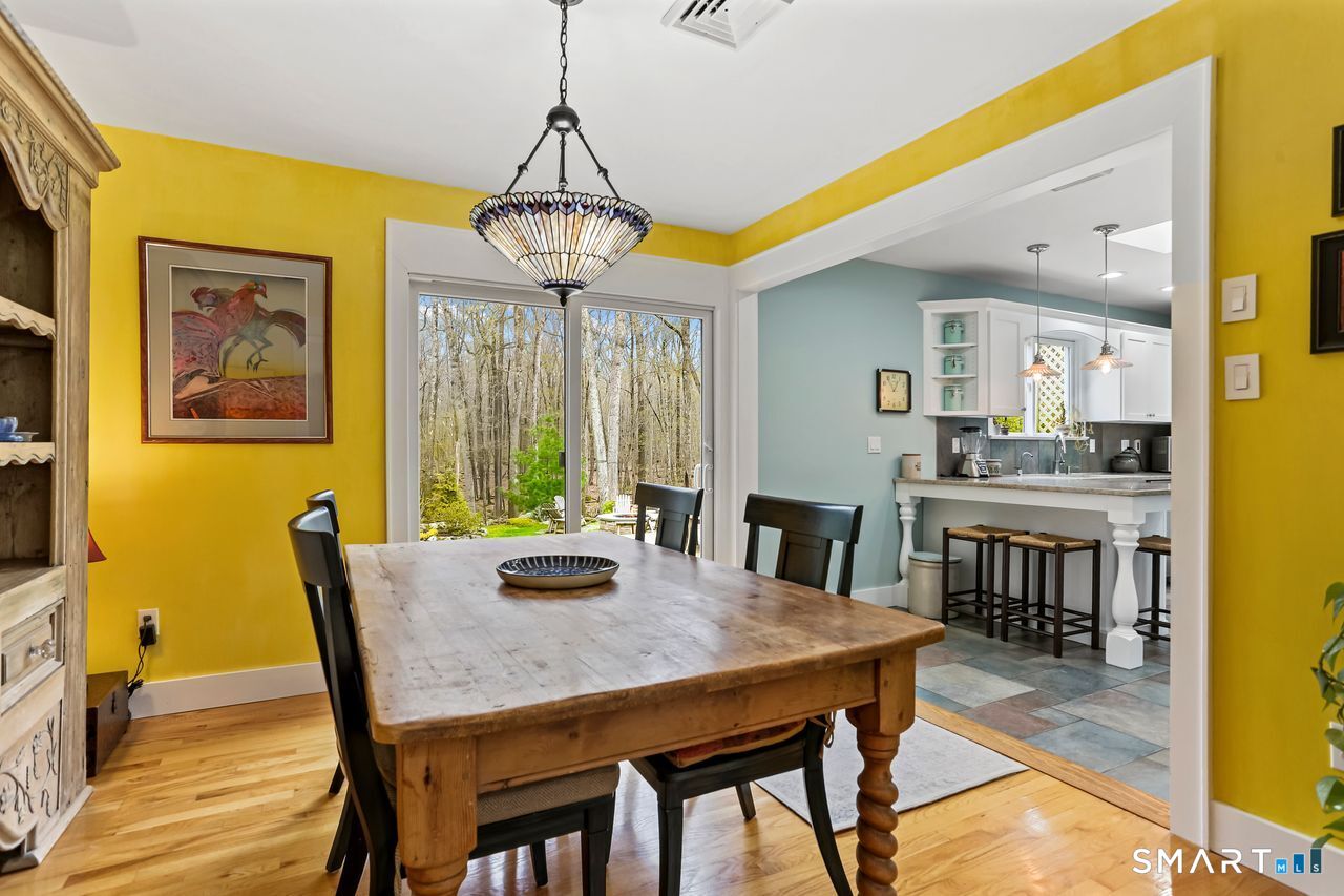 86 Seventy Acre Road Redding, CT 06896 - Photo 13 of 40 a view of a dining room with furniture window and wooden floor