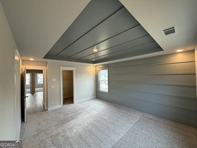 a spacious bathroom with a granite countertop sink mirror and shower