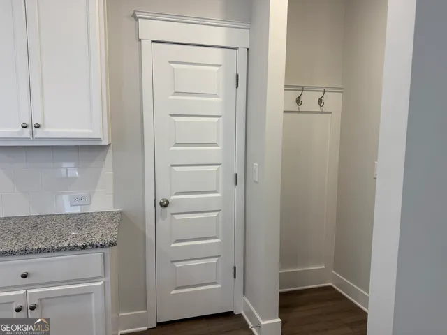 a view of walk in closet with hardwood floor