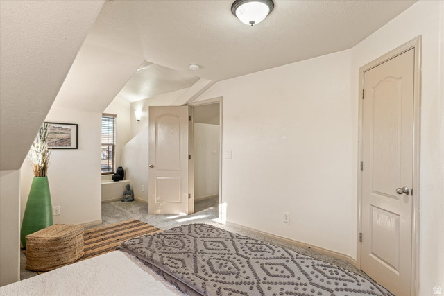 345 North 2450th Street East, Unit 152 St. George, UT 84790 - Photo 24 of 40 Bedroom featuring light carpet and lofted ceiling