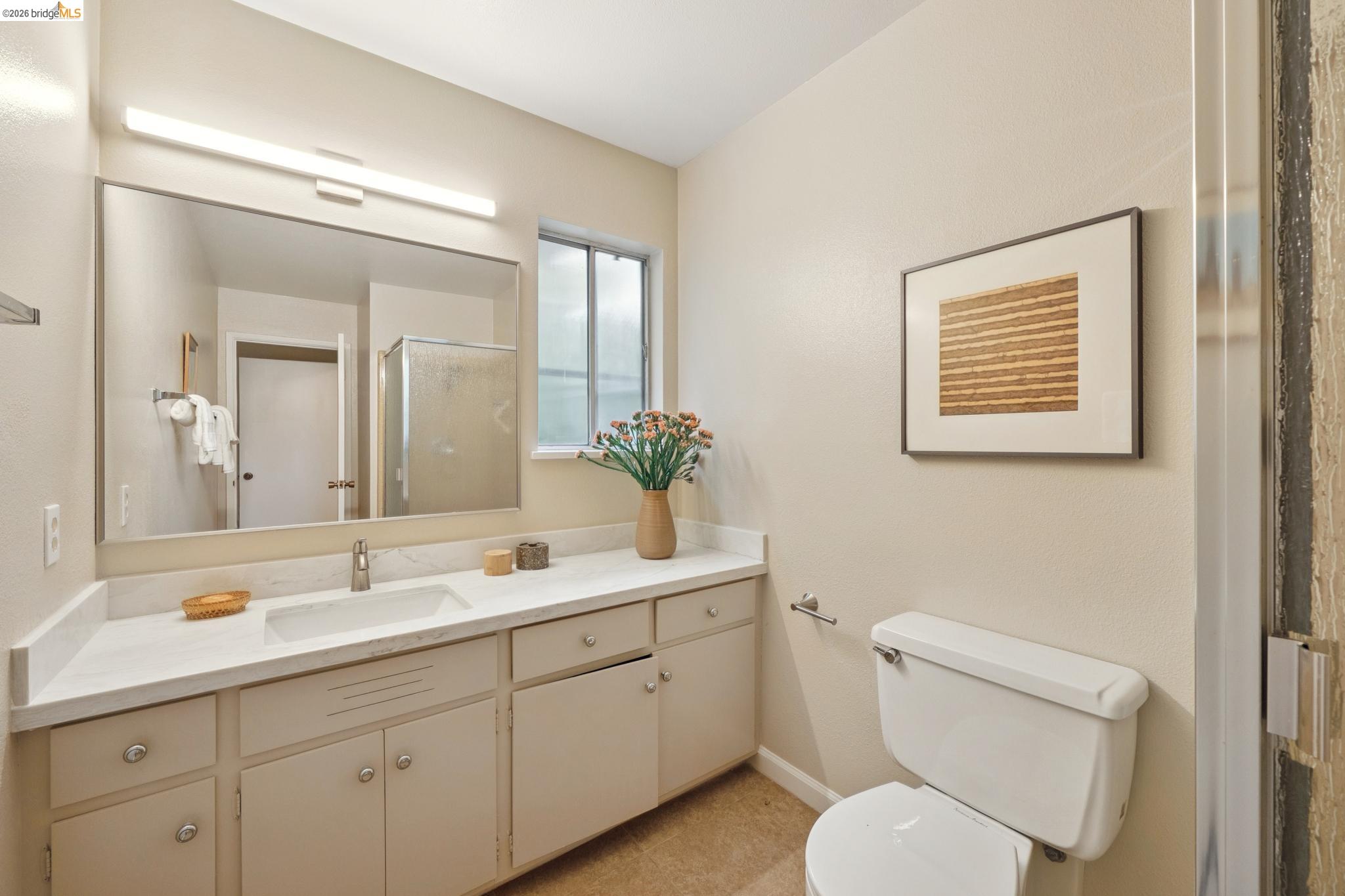 15 Christopher Court El Sobrante, CA 94803 - Photo 43 of 99 a bathroom with a toilet a sink and mirror