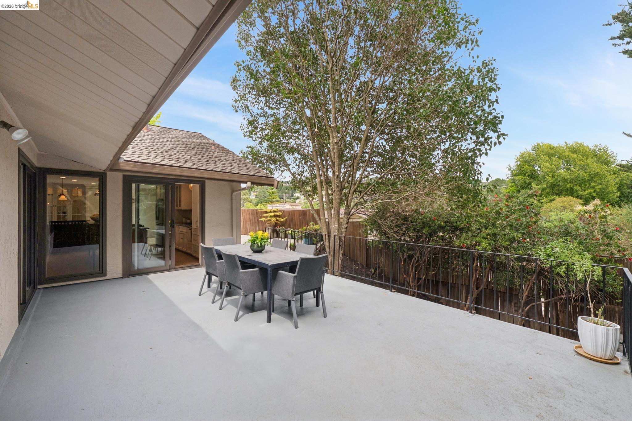 15 Christopher Court El Sobrante, CA 94803 - Photo 58 of 99 a view of a patio with table and chairs and floor to ceiling window