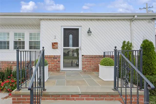 a pathway of a house with a yard