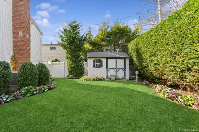a front view of a house with a garden and plants