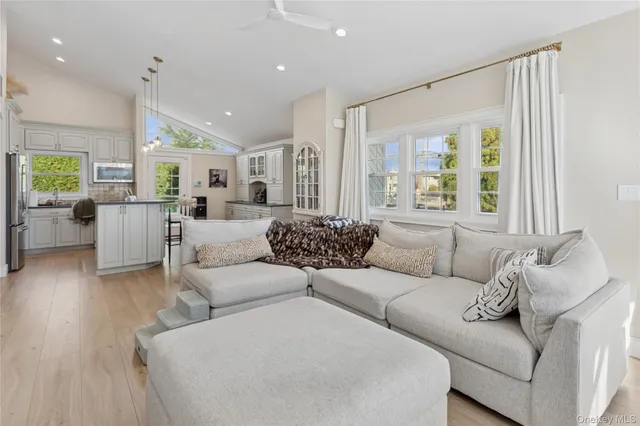 a kitchen with stainless steel appliances a stove a sink and a refrigerator with wooden floor