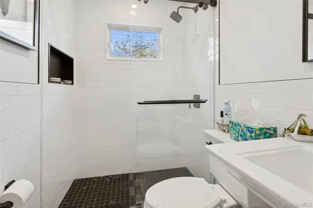 a bathroom with a granite countertop sink and a bathtub